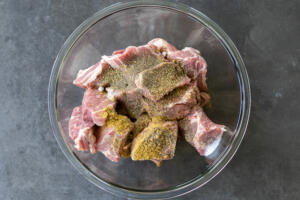 Pork and seasoning in a bowl.