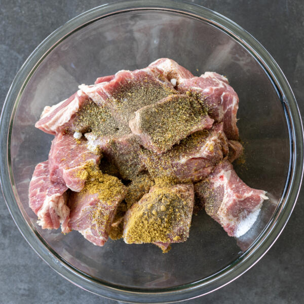 Pork and seasoning in a bowl.