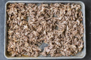 Shaved pork on a baking sheet.
