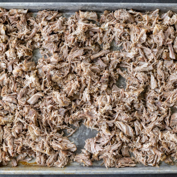 Shaved pork on a baking sheet.