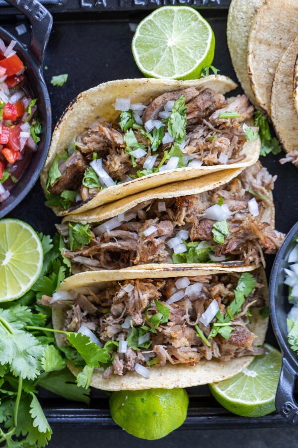 Pork Tacos with lime and toppings.