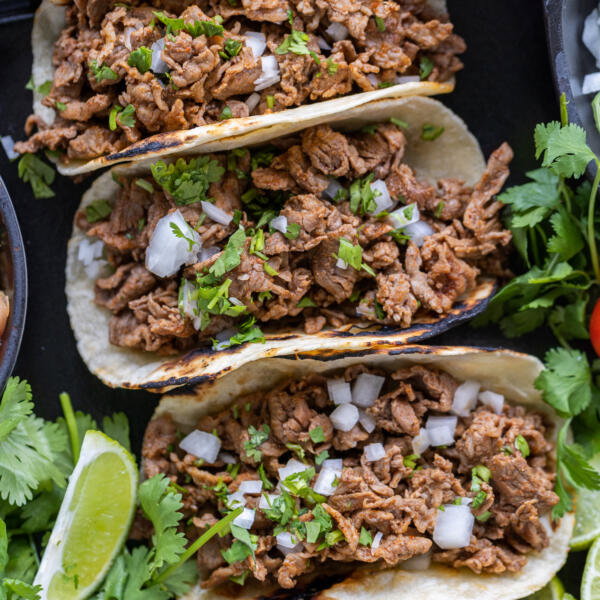 Shaved Beef Tacos with veggies and other toppings.