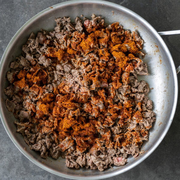 Cooked beef with taco seasoning in a pan.