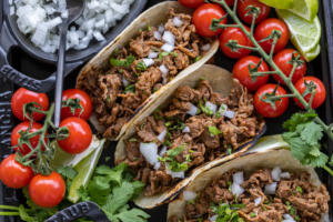 Shaved Beef Tacos with veggies and other toppings.