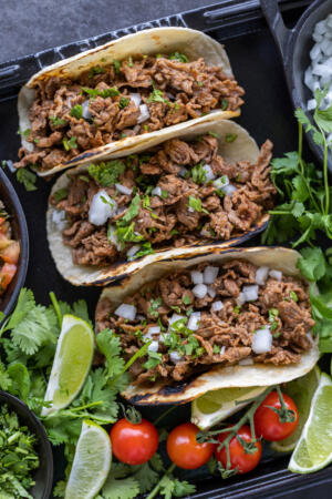 Shaved Beef Tacos with veggies and other toppings.
