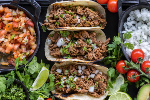 Shaved Beef Tacos with veggies and other toppings.