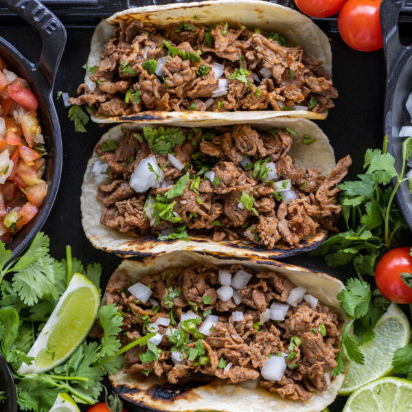 Shaved Beef Tacos with veggies and other toppings.