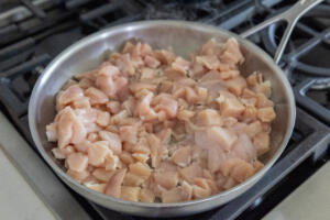 Chicken cooking in a pan.