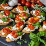 Tray with Burrata Crostini with Blistered Tomatoes.