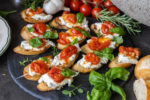 Tray with Burrata Crostini with Blistered Tomatoes.