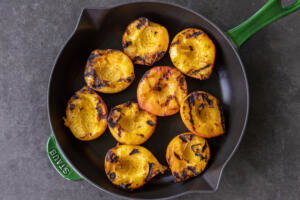 Grilled peaches in a serving tray.