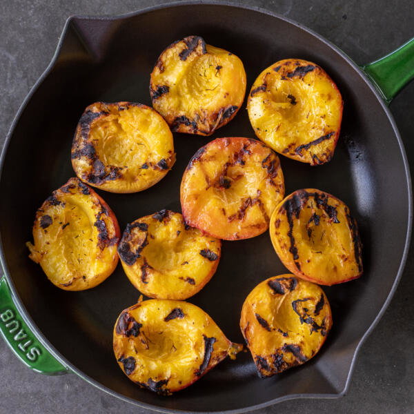 Grilled peaches in a serving tray.