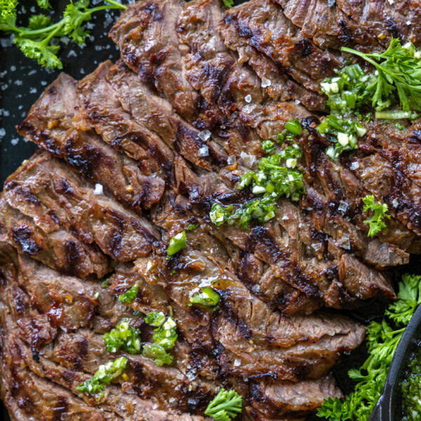 Sliced up Skirt Steak on a serving tray.