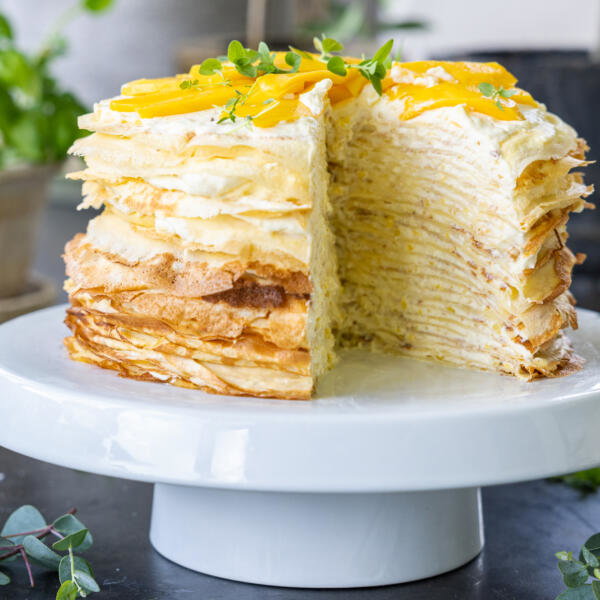 Sliced Mango Crepe Cake on a cake stand.