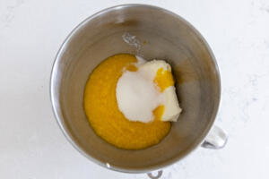 Cream cheese, sugar and mangos in a bowl.