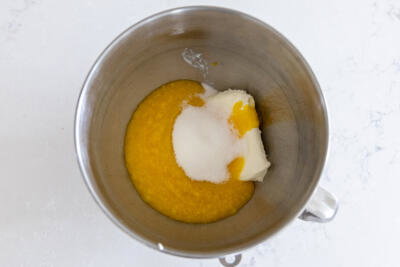 Cream cheese, sugar and mangos in a bowl.