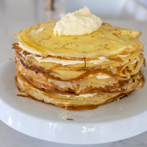 Crepes and cream on a cake stand.