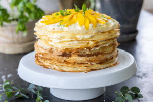 Mango Crepe Cake on a cake stand.