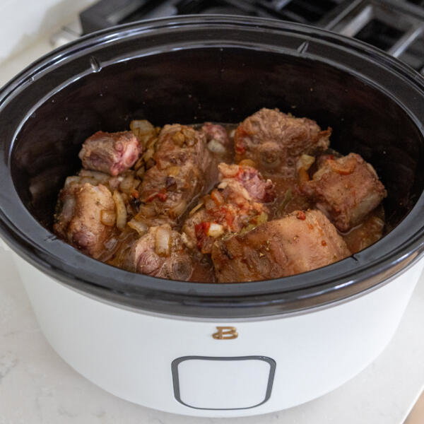 Slow cooker with all the oxtail ingredients.
