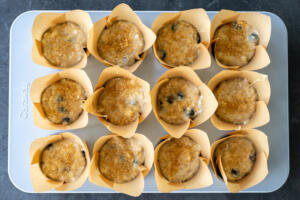 Muffins topped with corse sugar in a pan.