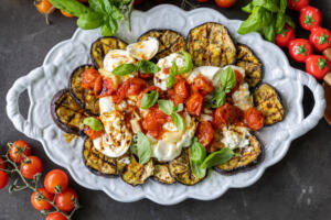 Serving tray with Grilled Eggplant with Burrata & Roasted Tomatoes.
