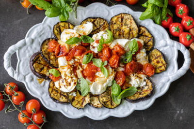 Serving tray with Grilled Eggplant with Burrata & Roasted Tomatoes.