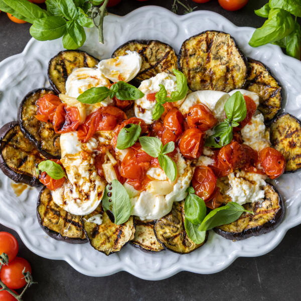 Serving tray with Grilled Eggplant with Burrata & Roasted Tomatoes.