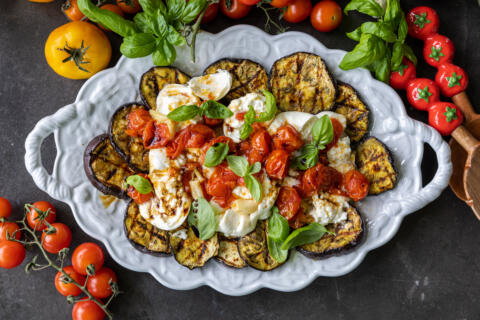 Serving tray with Grilled Eggplant with Burrata & Roasted Tomatoes.