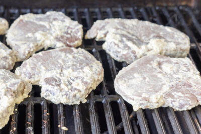 Pork Loin Chops cooking on a grill