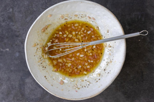 Tomato Burrata Salad dressing in a bowl.