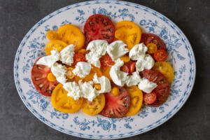 Burrata and tomatoes on a plate.