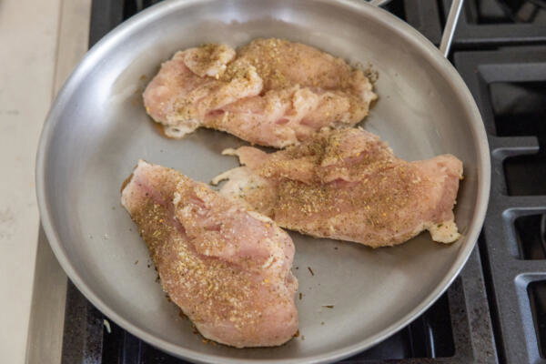 chicken cooking in a pan.