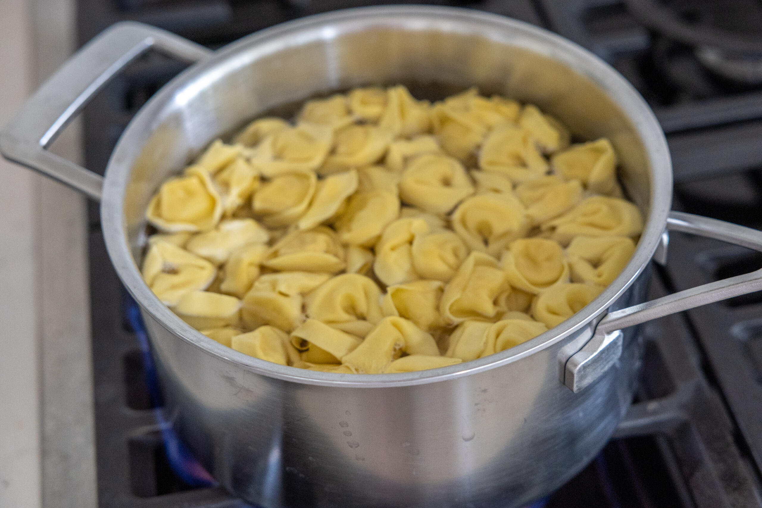Tortellini boiling in the water.