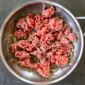 Ground beef cooking in a pan.
