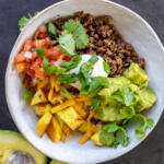 Loaded Potato Taco Bowl with herbs.