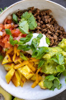 Loaded Potato Taco Bowl with herbs.