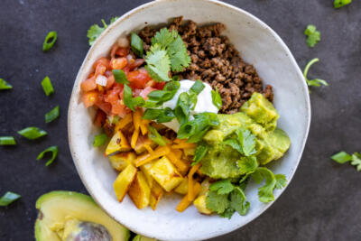 Loaded Potato Taco Bowl with herbs.