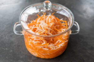 Pickled Daikon Radish and Carrots in a container.
