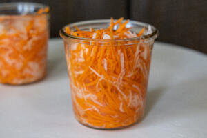 Pickled Daikon Radish and Carrots in a container.
