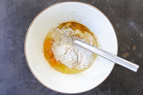 Ingredients for Sourdough Cottage Cheese Pancakes in a bowl.